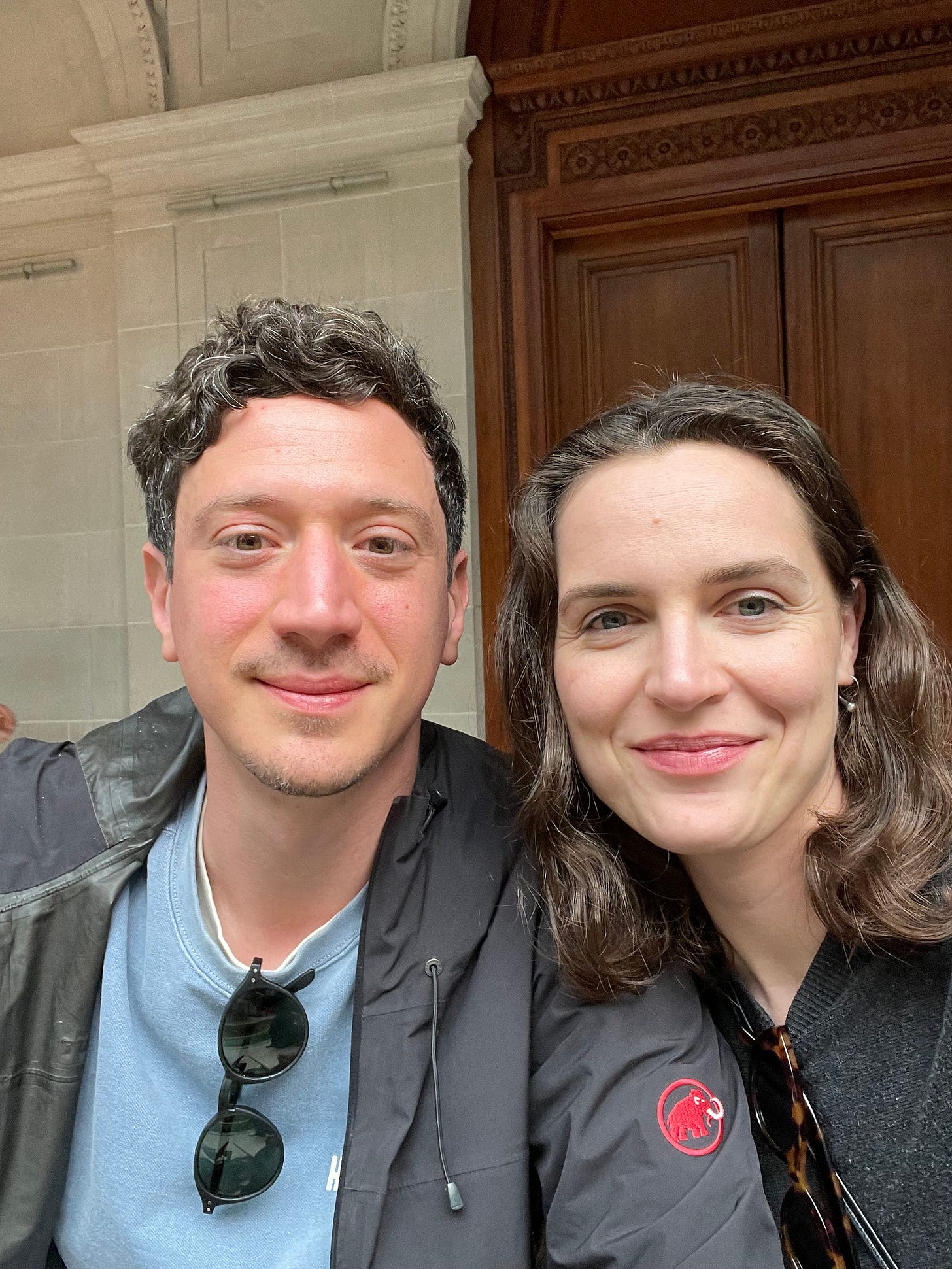 A man and woman seated in a garden court taking a selfie A man and woman seated in a garden court taking a selfie