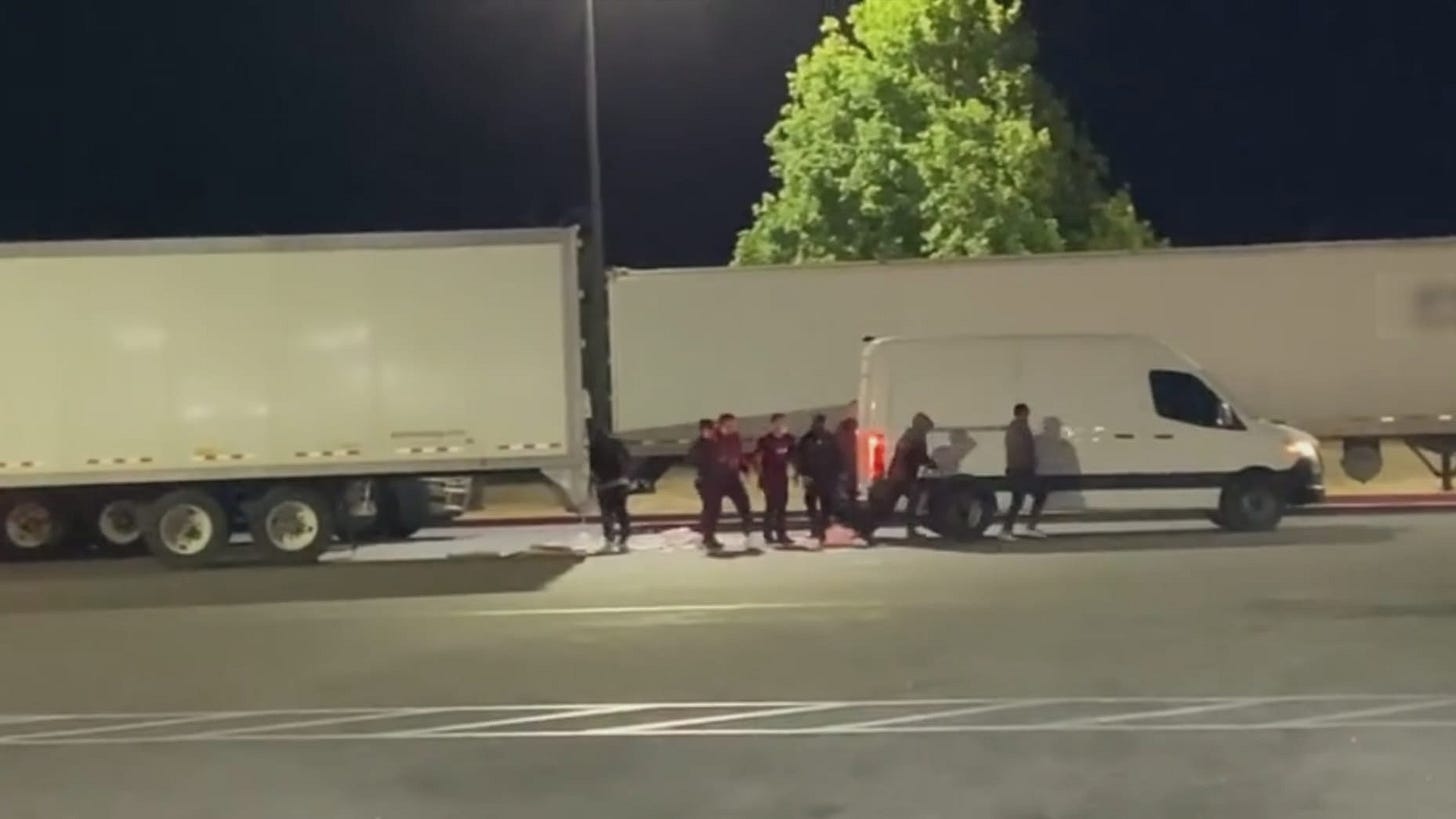 A group of suspects is shown stealing cargo from a truck and loading it into their vehicle last year in California.