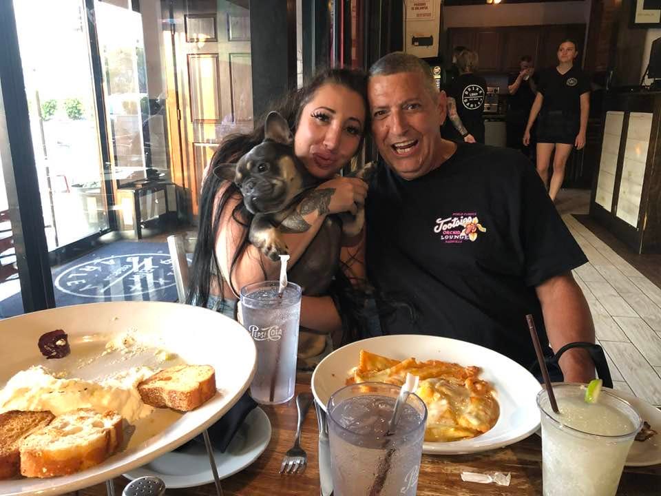May be an image of 2 people and dog