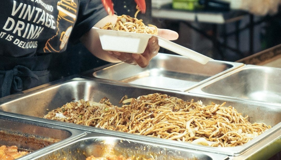 a woman in a black shirt is serving food