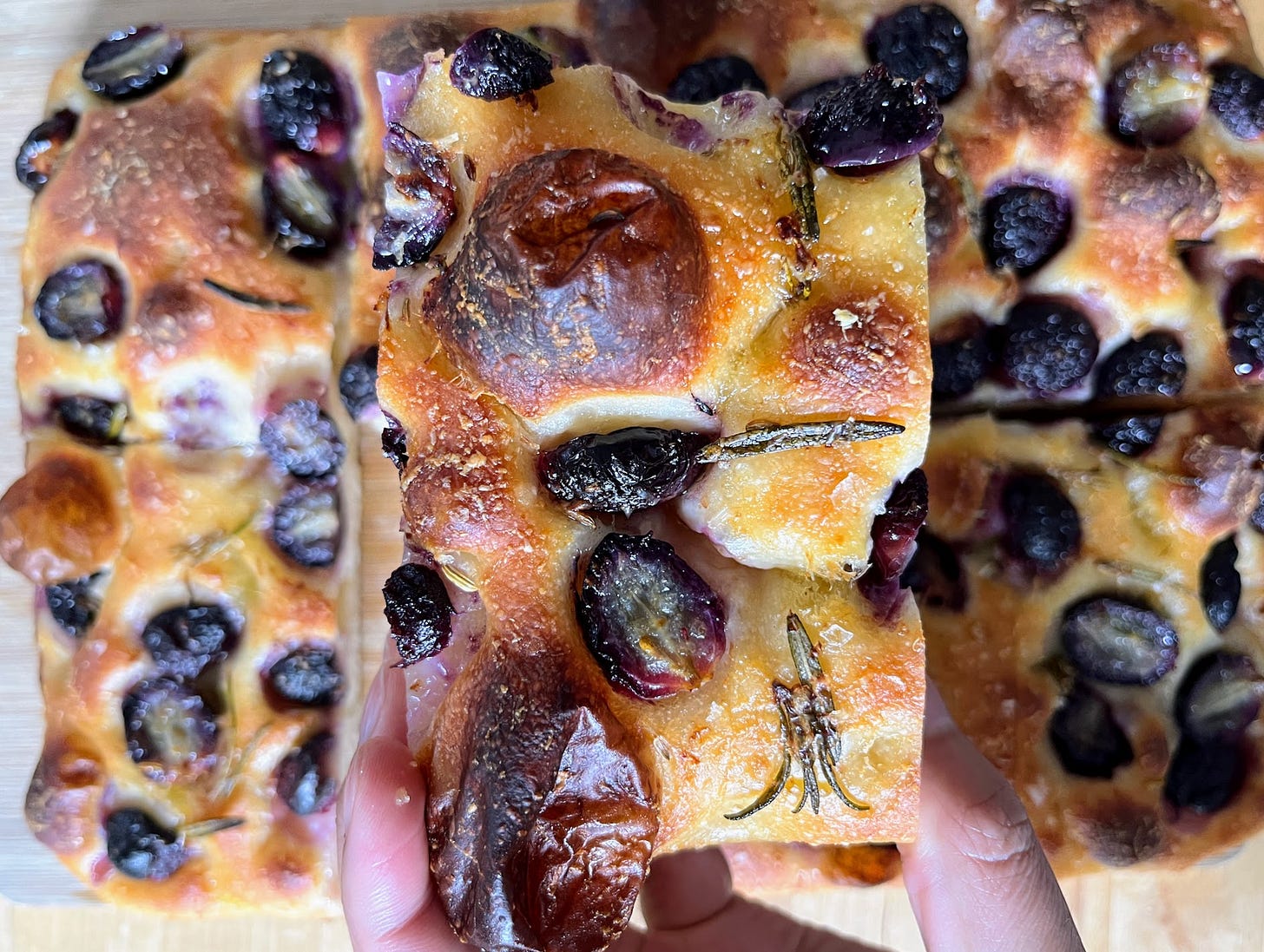 Hand holding grape focaccia