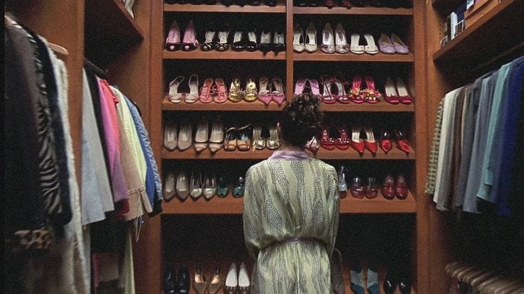 This may contain: a woman standing in front of a closet filled with shoes