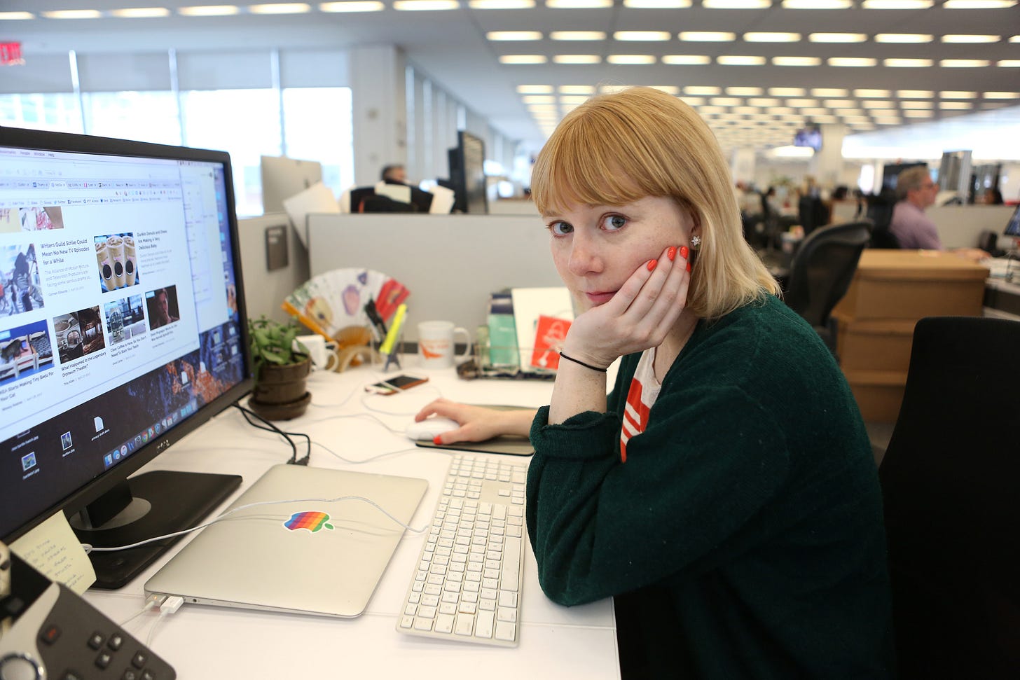 New York Times critic at large Amanda Hess sits at her desk in the newsroom.
