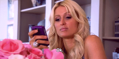 A woman looks at her phone and says OK