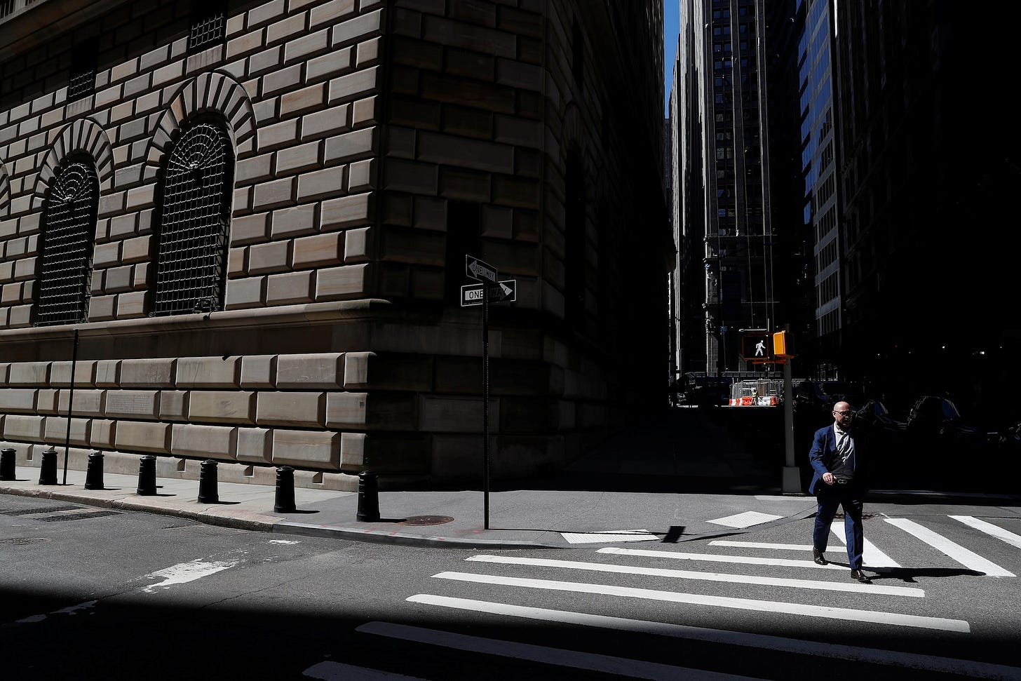 A man walks by the Federal Reserve Bank of New York Building in New York City A man walks by the Federal Reserve Bank of New York Building in New York City