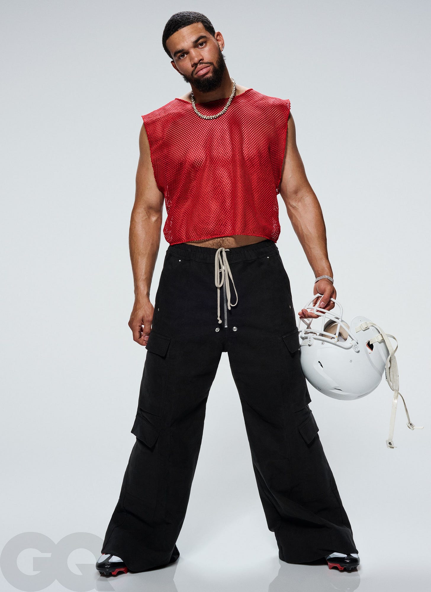 Tank top from New BedStuy. Pants by Rick Owens. His own cleats by Nike. Earrings  his own. Necklace by Greg Ross....