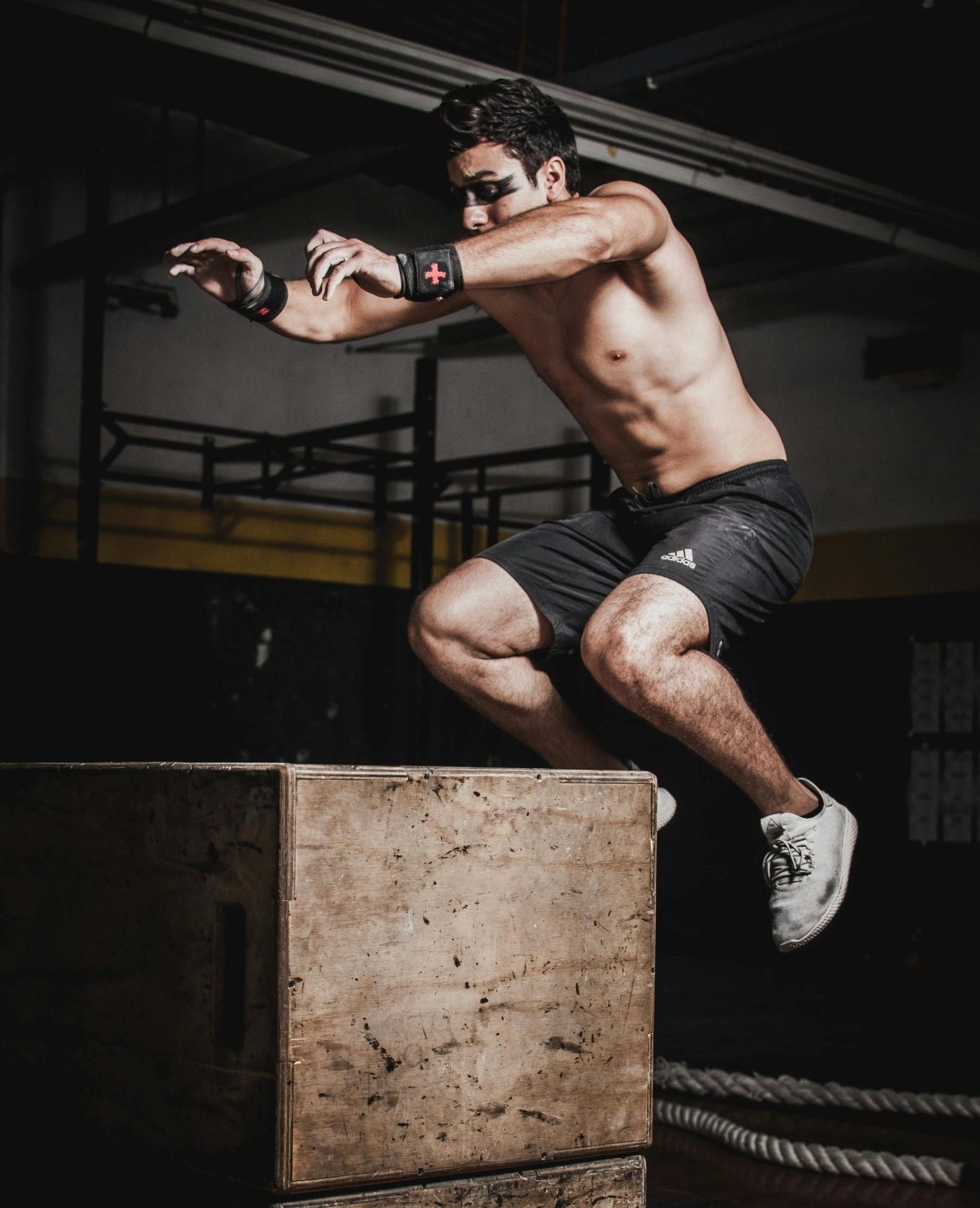 CrossFit athlete performing box jumps at Canggu gym in Bali - functional fitness training and high-intensity workout CrossFit athlete performing box jumps at Canggu gym in Bali - functional fitness training and high-intensity workout