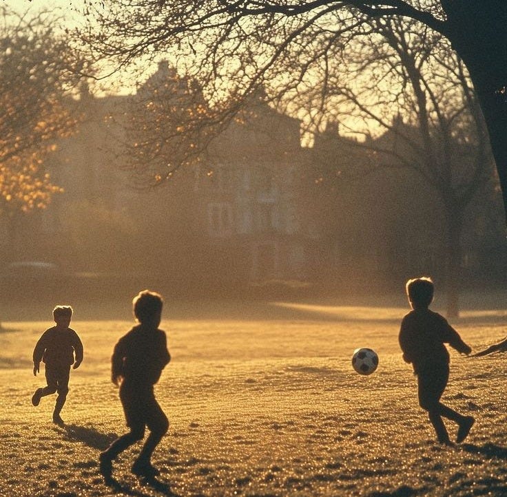 This may contain: three young boys playing soccer in the park at sunset or dawn with their shadows on the grass This may contain: three young boys playing soccer in the park at sunset or dawn with their shadows on the grass