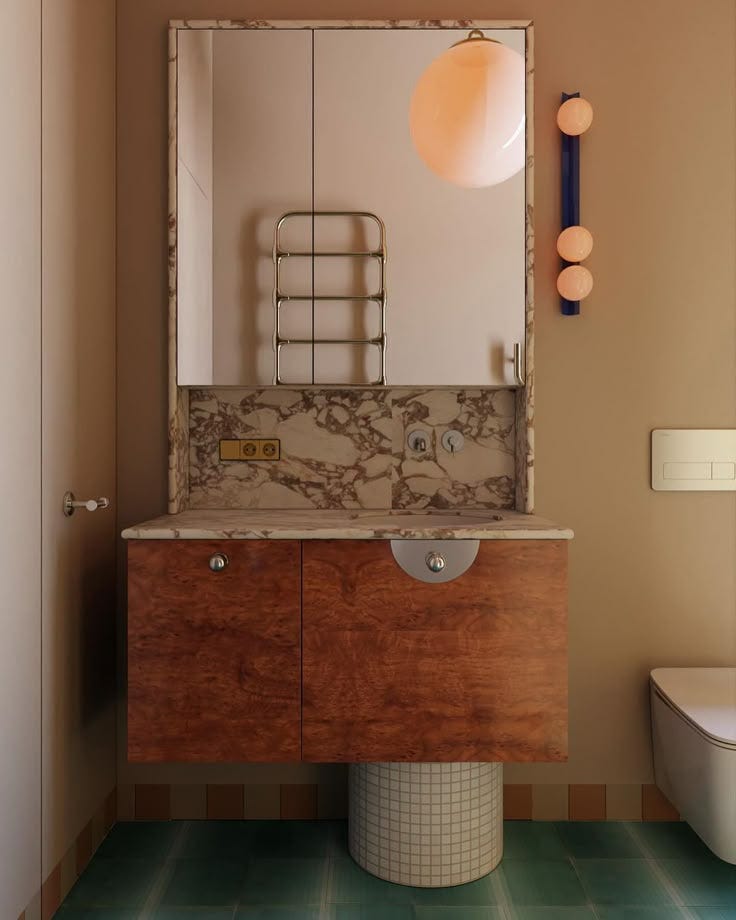 This may contain: a bathroom with a sink, mirror and toilet in the corner next to a wall mounted light