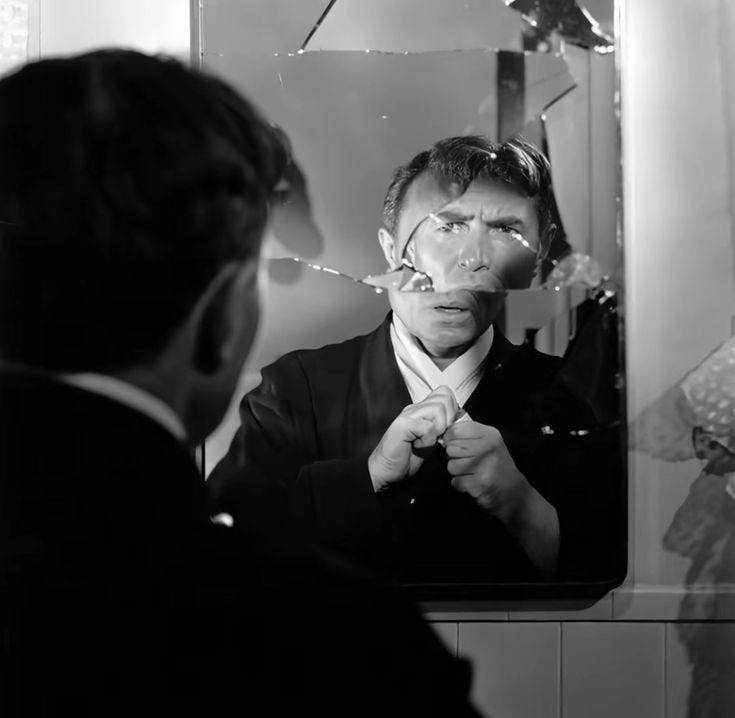 This may contain: a man is looking at his reflection in the mirror while he ties his necktie