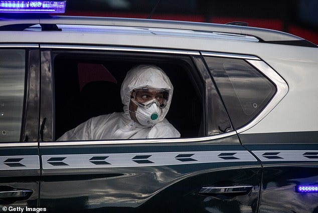 A member of the Guardia Civil sits in a car during the evacuation of passengers from the MV Hondius after docking in the Granadilla Port on May 11