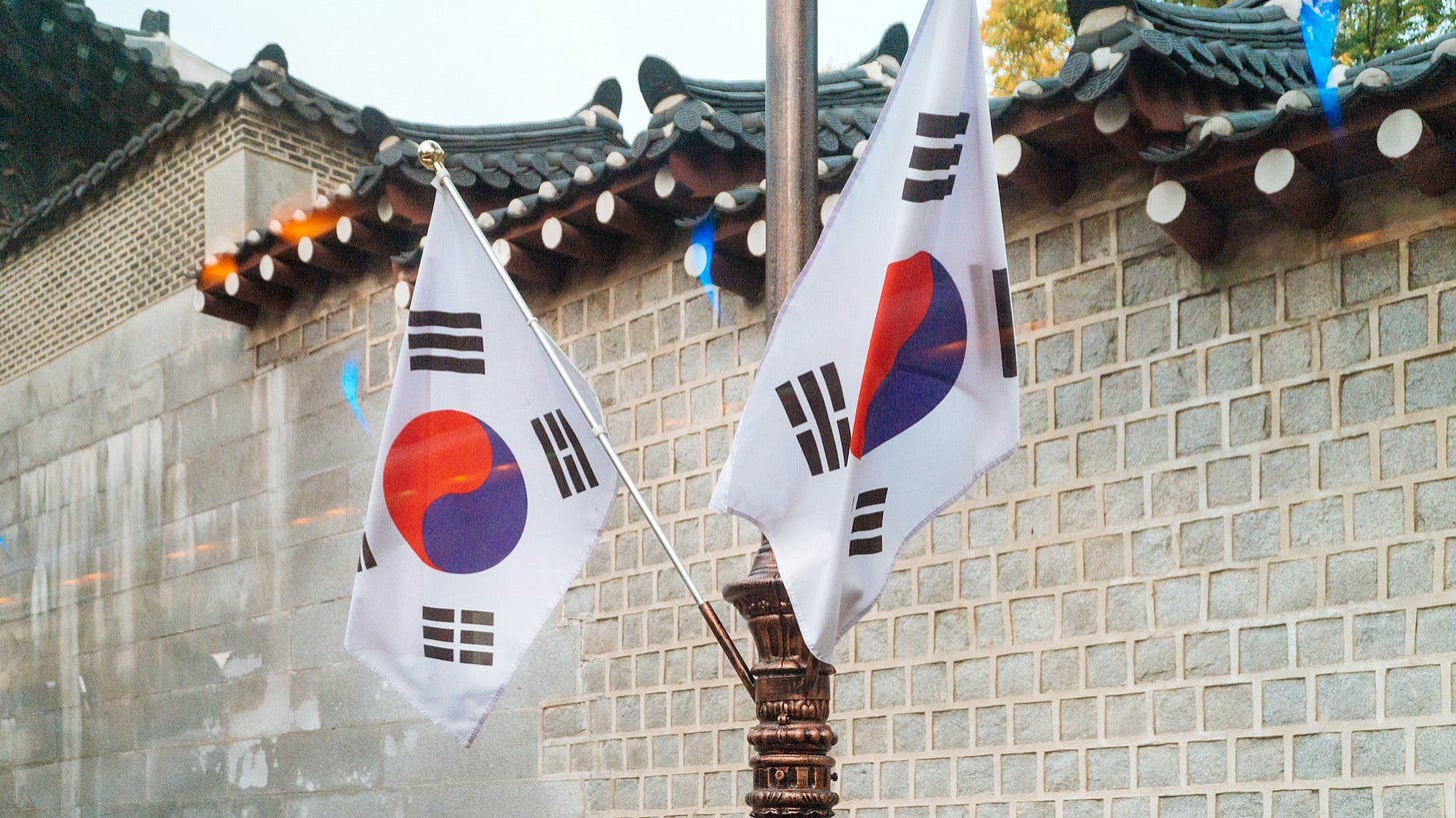 Photo by <a href="https://unsplash.com/@stephnakagawa?utm_content=creditCopyText&utm_medium=referral&utm_source=unsplash">Stephanie Nakagawa</a> on <a href="https://unsplash.com/photos/two-korea-national-flags-mKFsEboJ1xA?utm_content=creditCopyText&utm_medium=referral&utm_source=unsplash">Unsplash</a>       