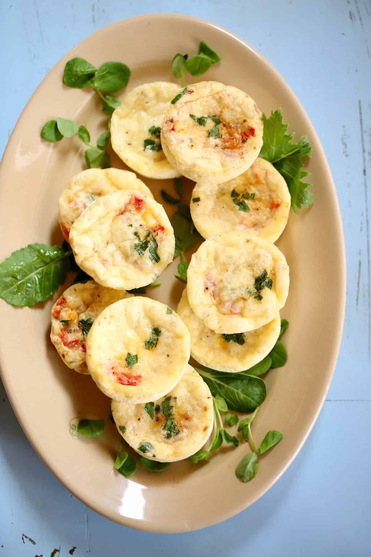 a beige tray of egg white bites. a beige tray of egg white bites.