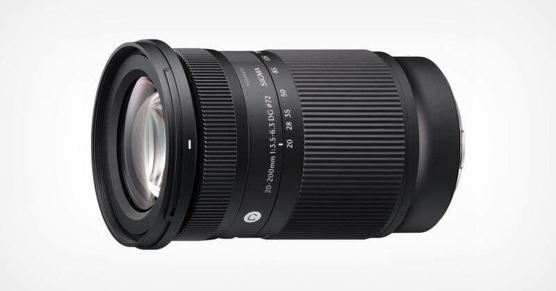 A black Sigma 18-200mm camera lens with zoom and focus rings, placed on a white background. The lens has white markings indicating focal lengths and other specifications.