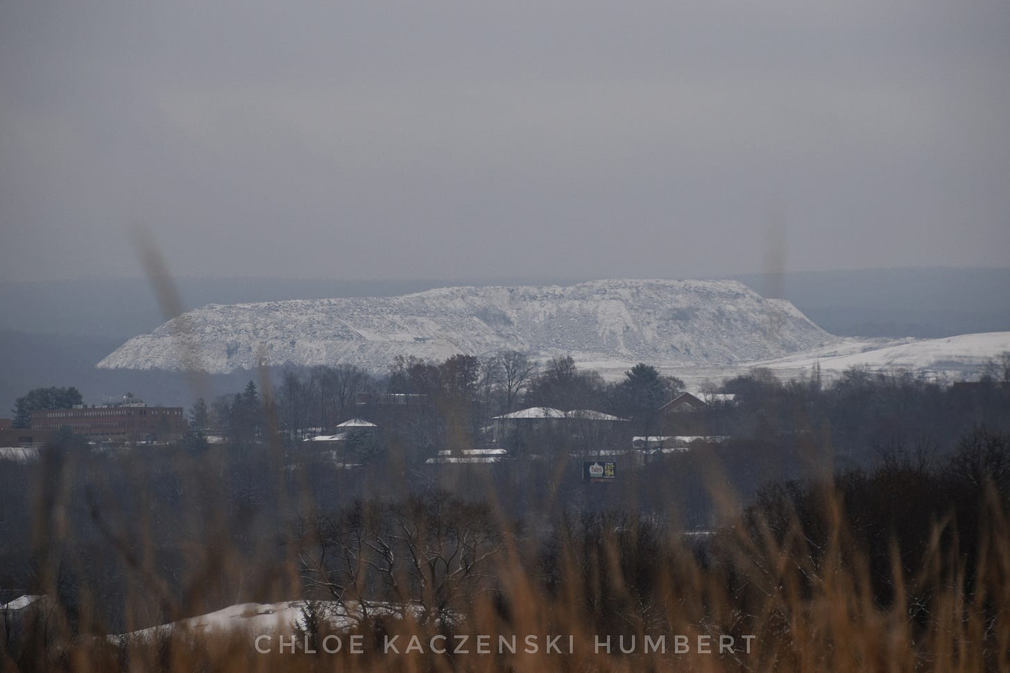 View of the snow covered Keystone Landfill garbage dump mountain in Dunmore seen from across the Lackawanna River valley from Scranton Pennsylvania. Photo by Chloe Kaczenski Humbert. November 28, 2021. View of the snow covered Keystone Landfill garbage dump mountain in Dunmore seen from across the Lackawanna River valley from Scranton Pennsylvania. Photo by Chloe Kaczenski Humbert. November 28, 2021.