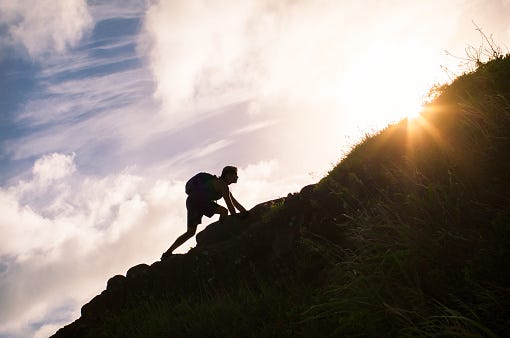 Young Man Climbing Up A Mountain Stock Photo - Download Image Now -  Climbing, Effort, Conquering Adversity - iStock