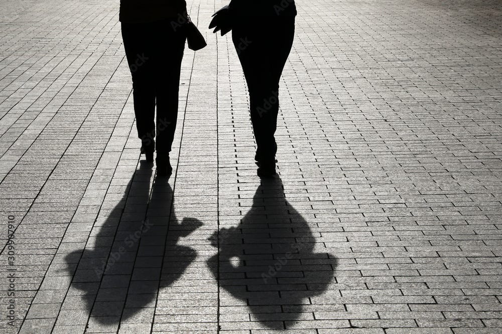 Two women walking down the street, silhouettes and shadows on pavement.  Female couple on a sidewalk, concept of female friendship, dramatic life  stories Stock Photo | Adobe Stock
