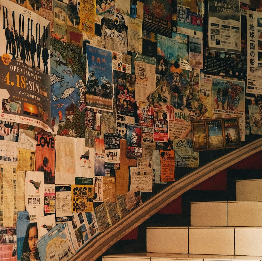 a bunch of newspapers are on the wall next to the stairs