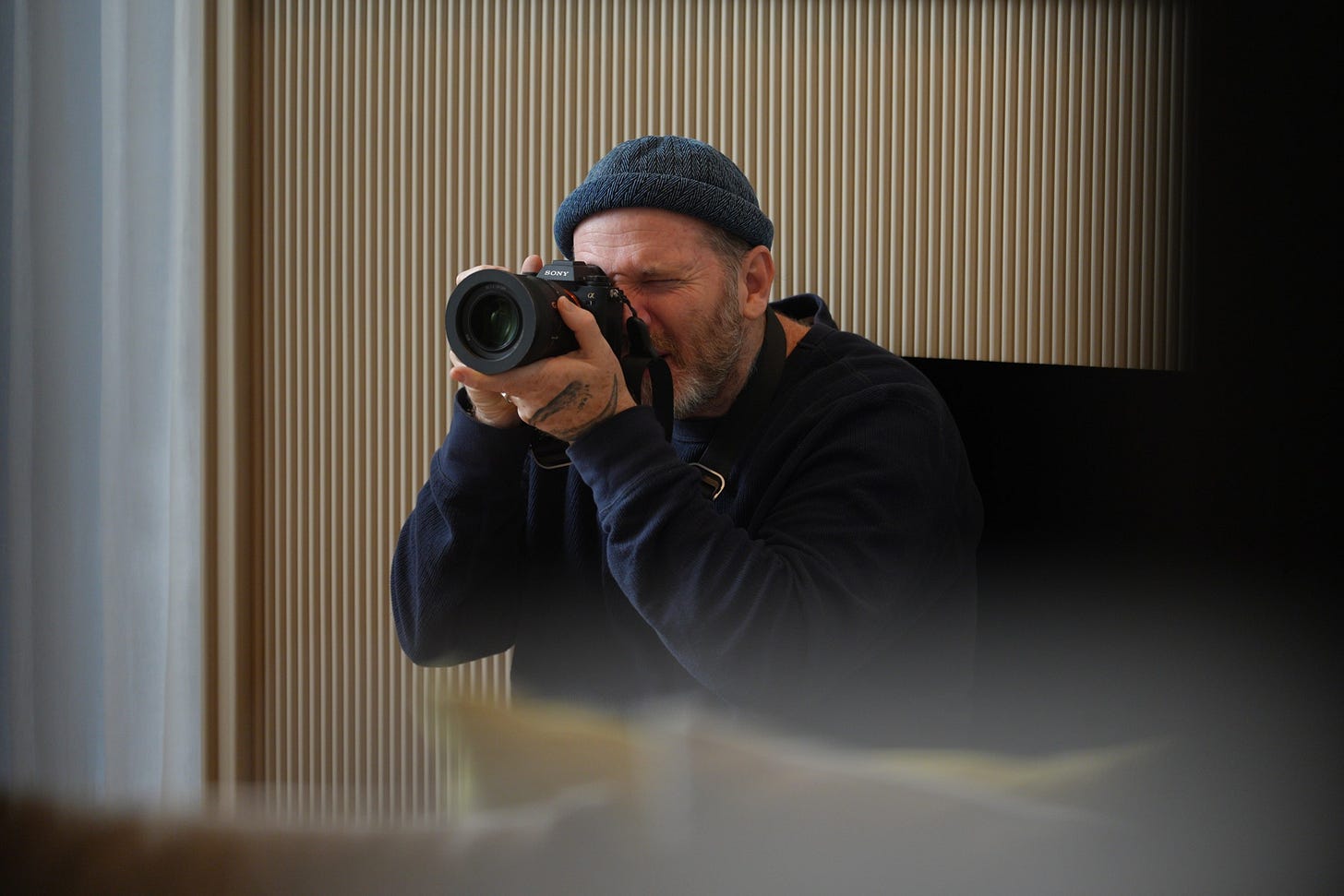 Justin Mott using a Sony camera to photograph indoors