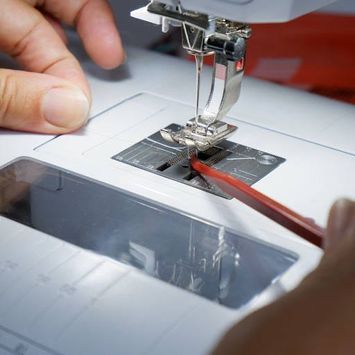 picking up the bobbin thread with the help of a sewing stiletto