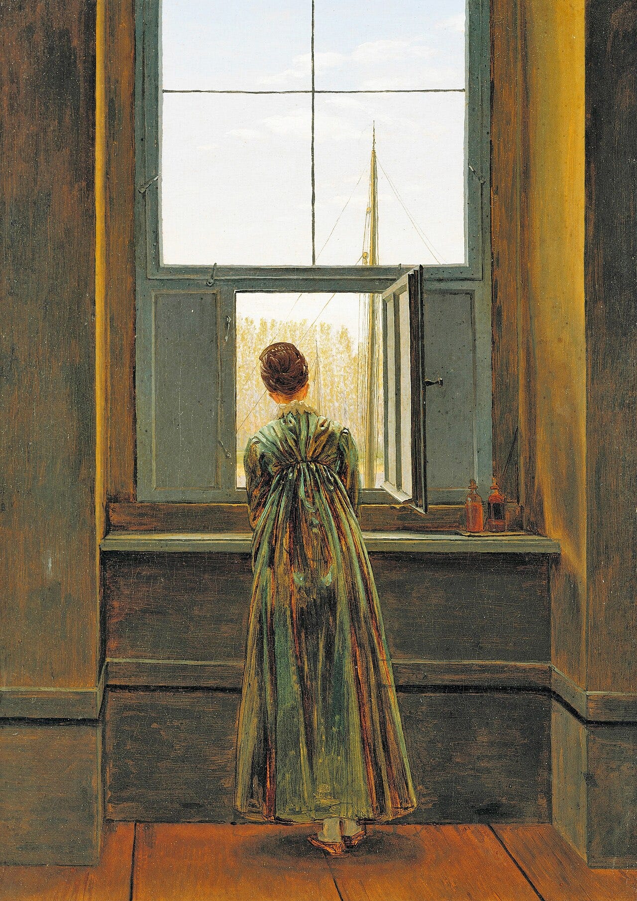Woman seen from behind leaning to an open window Woman seen from behind leaning to an open window