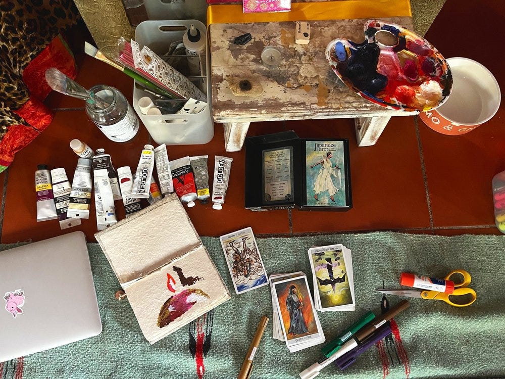 muunie beard creative life coach art supplies and tarot cards spread out everywhere in process blog