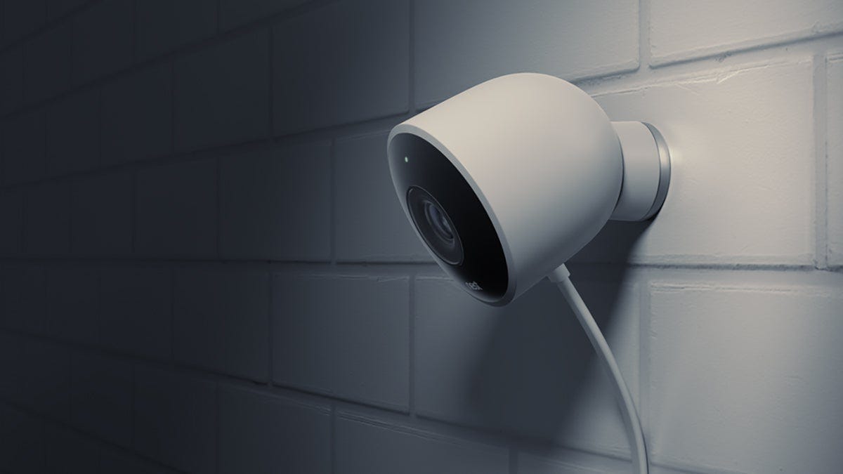 Security camera mounted on a white tile wall