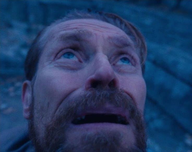 This may contain: a man with blue eyes looking up at something