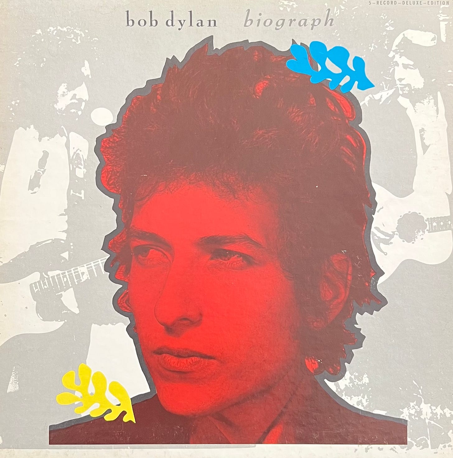 Image is of the outside of the front of Bob Dylan's Biograph boxed set. It contains a red image of a young Bob Dylan with faded black and white images of Dylan performing in the background.