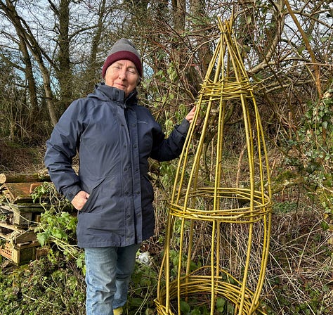 Stems of willow bound at base and top and then a completed obelisk