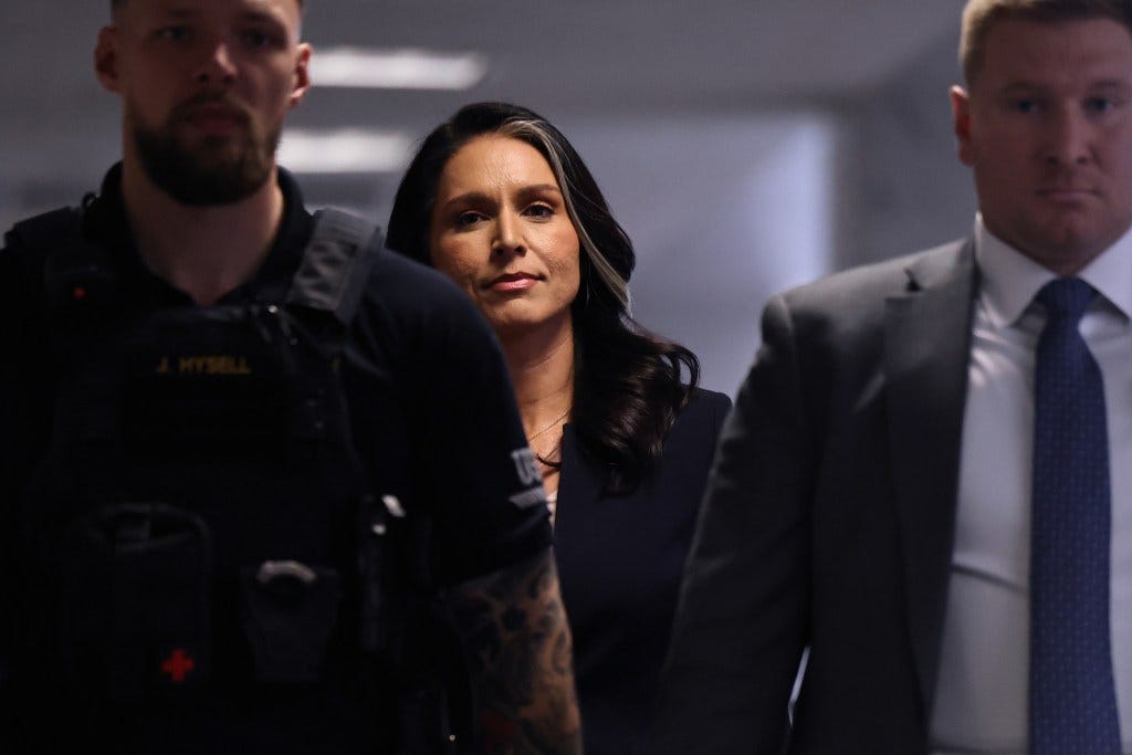 Former U.S. Rep. Tulsi Gabbard from Hawaii is escorted by police as she move between meetings with senators in the Hart Senate Office Building on Capitol Hill on December 18, 2024 in Washington, DC.