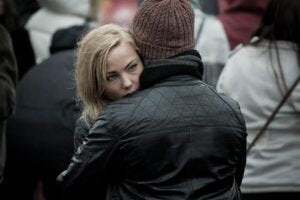 woman hugging a man dressed in black