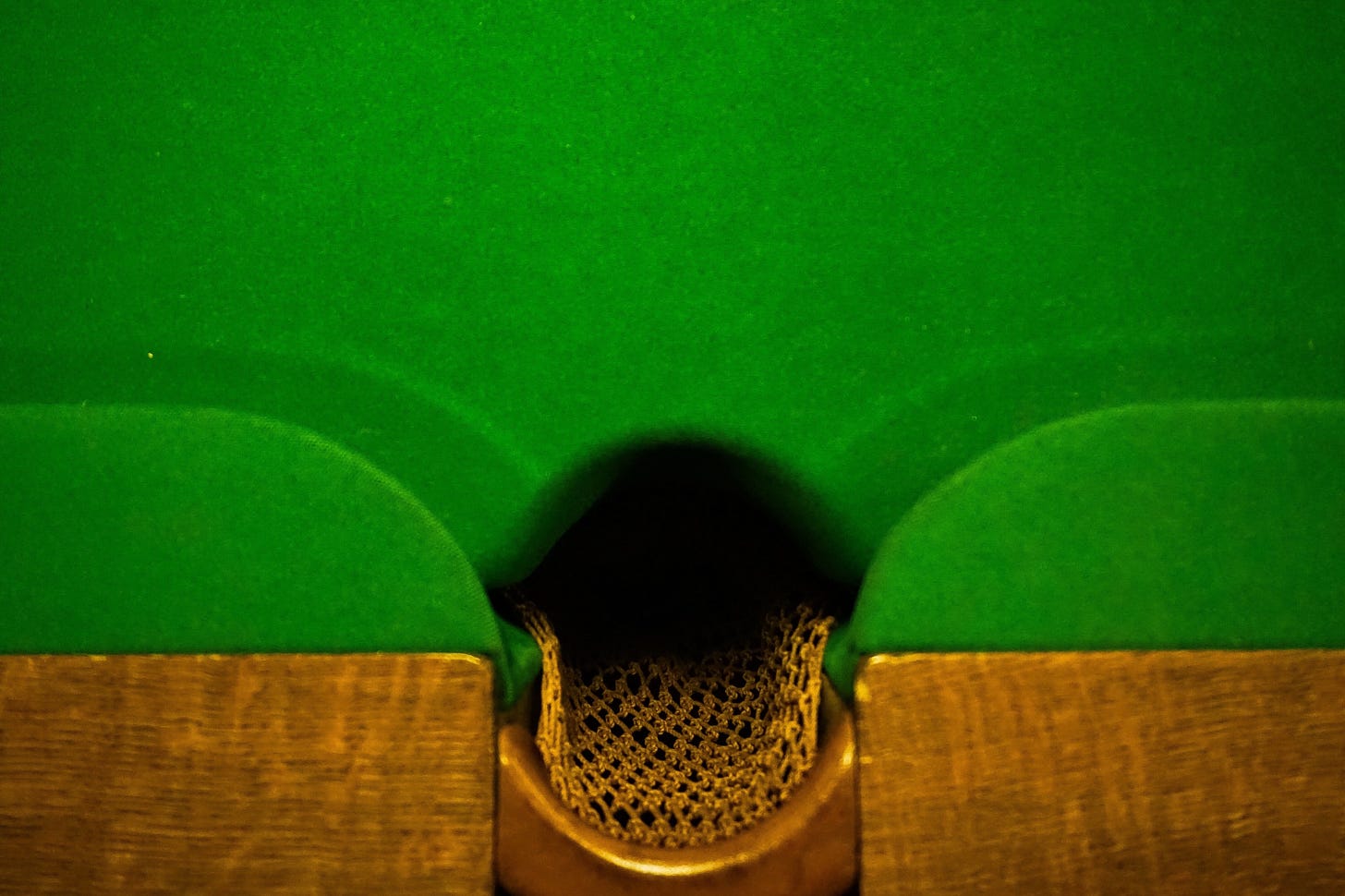 Classic antique style billiards table with knit pocket and Kelly green felt