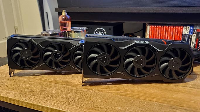 AMD Radeon RX 7900 XTX and 7900 XT on table AMD Radeon RX 7900 XTX and 7900 XT on table