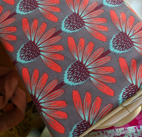pictures of fabrics, far left is an assembled hexagon quilt with fussy-cut hexagons cut from the fabric on the right