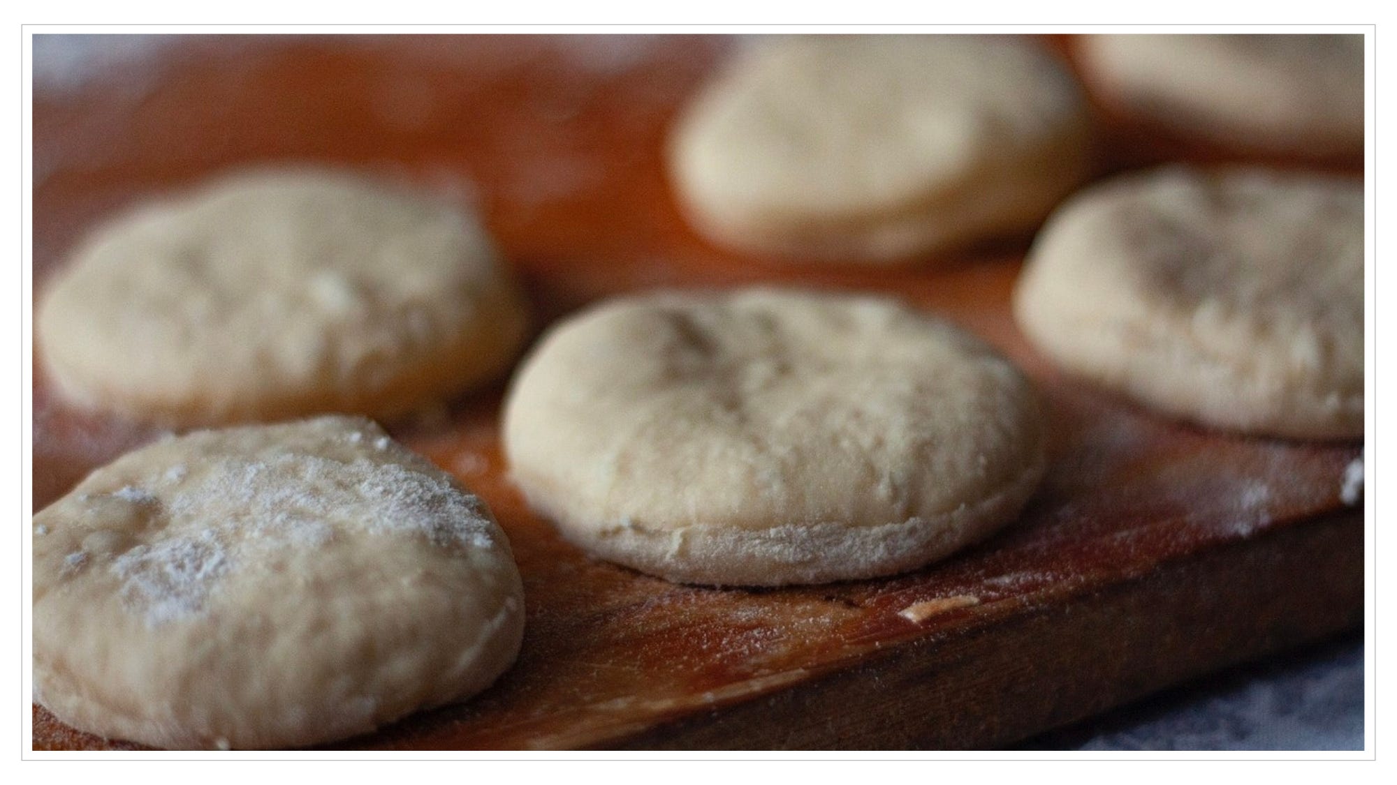 biscuit dough rounds on wood board