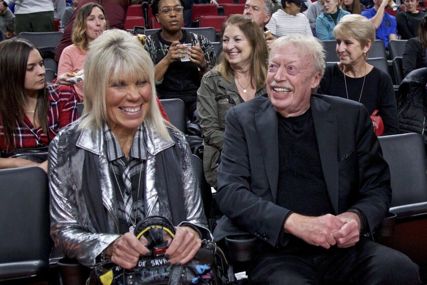 Phil Knight, right, and Penny Knight, left, during the first half of an NCAA college basketball game in the Phil Knight Invitational tournament in Portland, Ore., Sunday, Nov. 26, 2017.