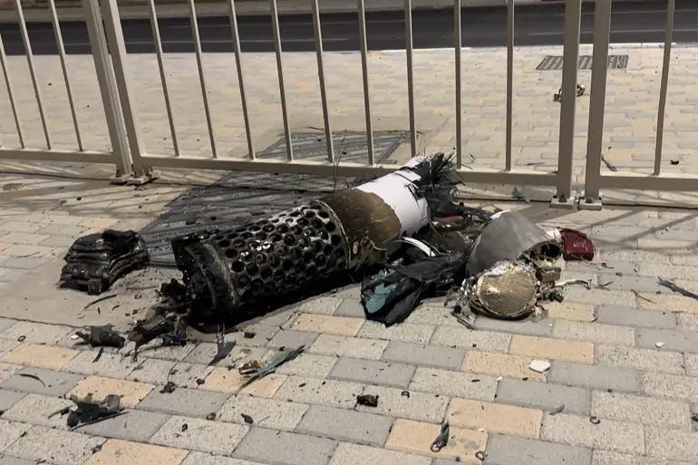 The remnants of an Iranian missile intercepted over Qatar, as it lies on a pavement near a fence, are seen on June 23, 2025 [AFPTV]