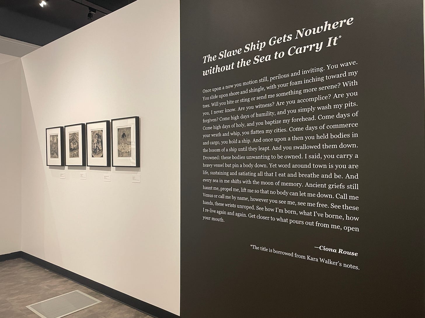 Black and white wall panel with an original essay by Ciona Rouse and four horizontal prints of Walker's art