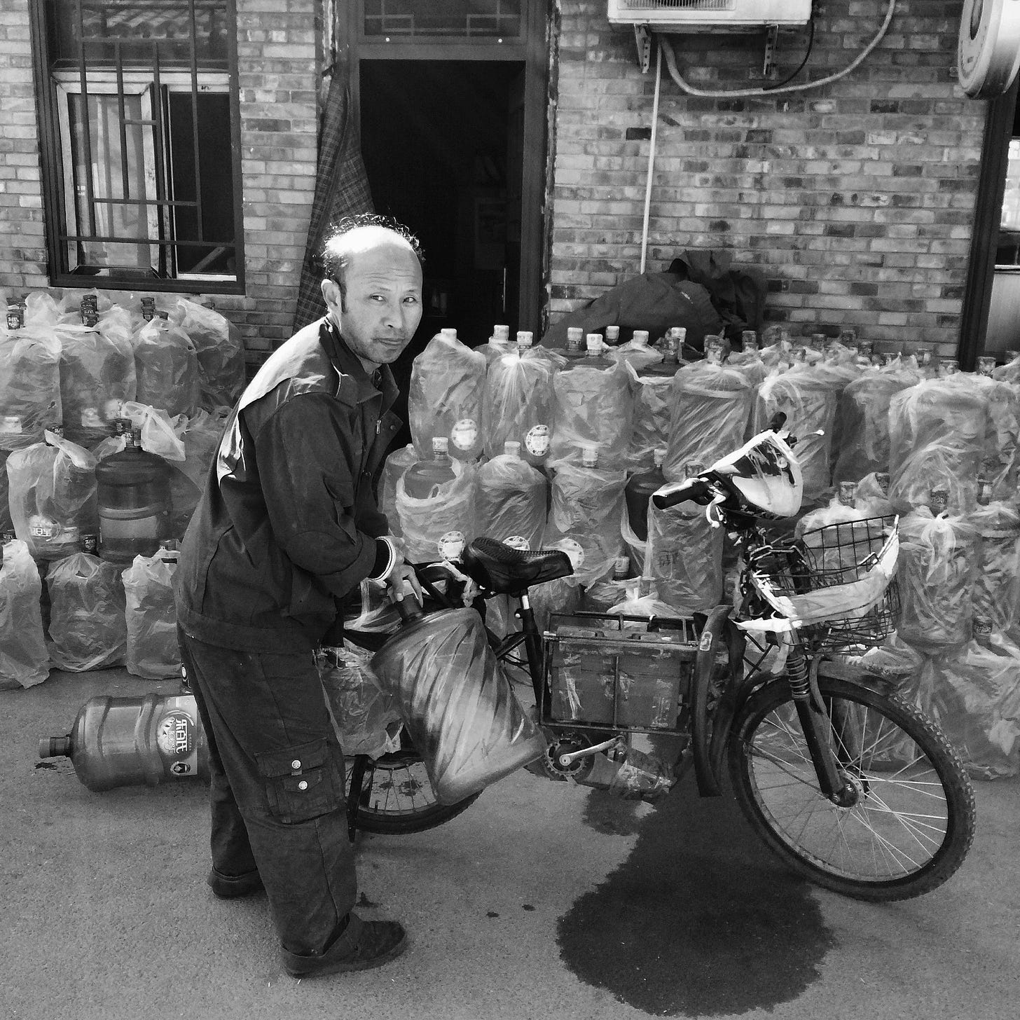 A delivery worker outside a water station in Beijing, one of many distribution points for huge barrels of drinking water.