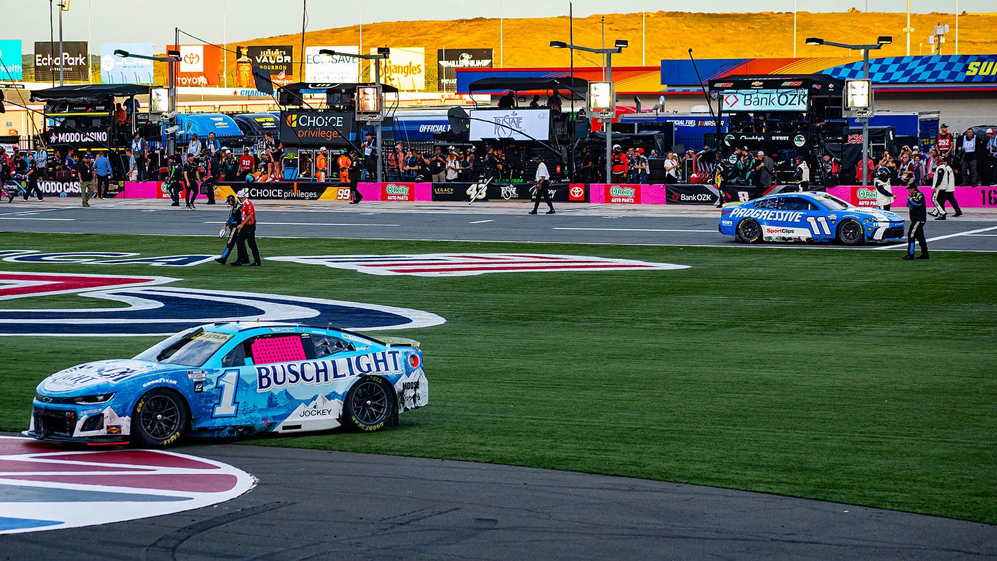 Ross Chastain's car sits in the frontstretch grass after a last-ditch effort to advance in the Playoffs at the Bank of America Roval 400 at the Charlotte Roval