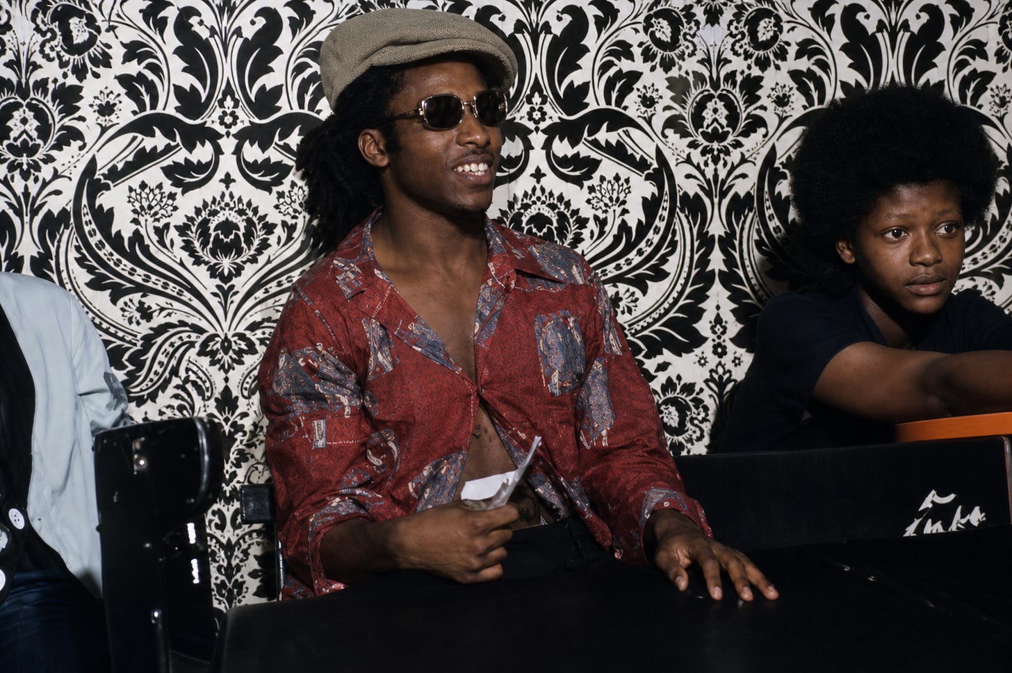 A relaxed, off-stage moment captures the style and confidence of a generation, where fashion, identity, and music moved together as one cultural force.
