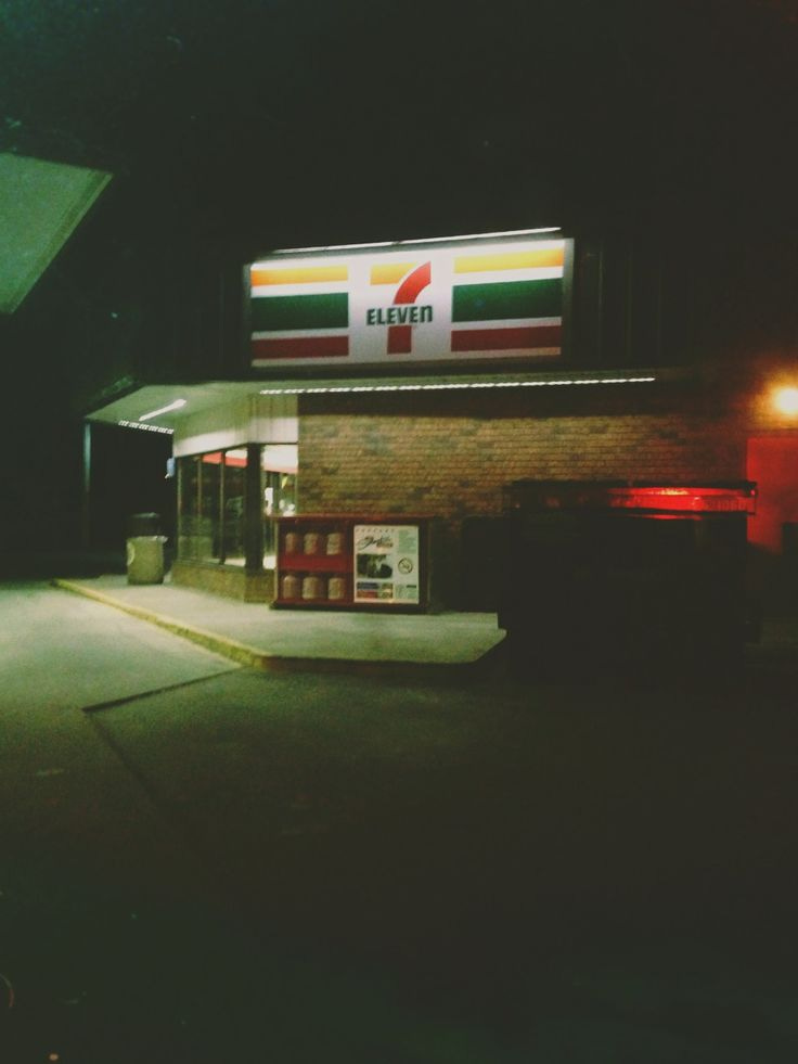 This may contain: a gas station at night with the lights on