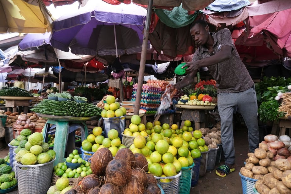 A man watching over his stall in an open market A man watching over his stall in an open market
