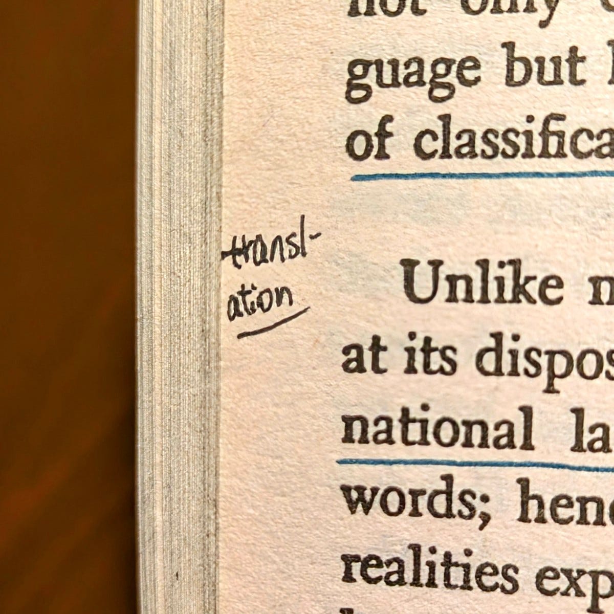 Close-up on a marginal note in a book that reads: translation.