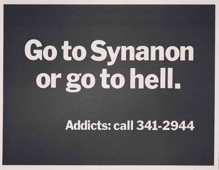 a sign reading 'Go to synanon or go to hell'