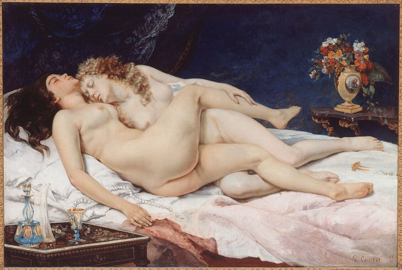 Two women asleep tangled together in a bed Two women asleep tangled together in a bed