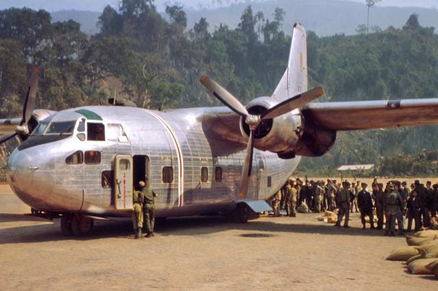 An Air America C-123 delivering supplies and picking up Laotian troops at Long-Tieng. An Air America C-123 delivering supplies and picking up Laotian troops at Long-Tieng.