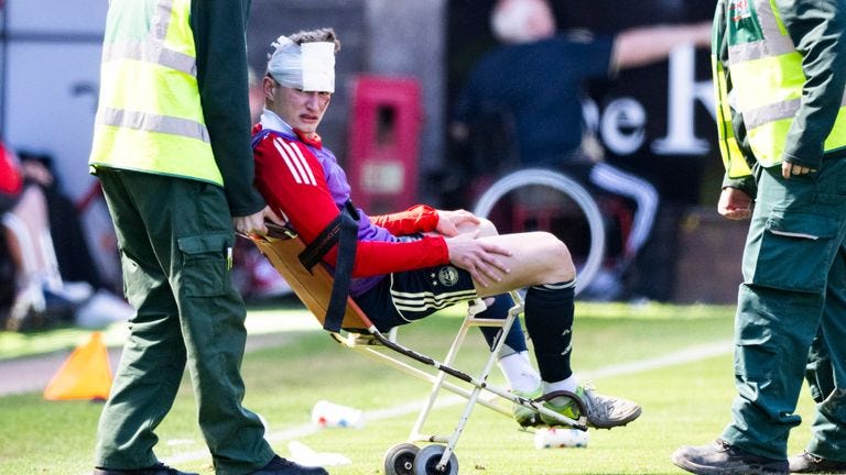 Aberdeen's Jack MacKenzie receives treatment after being hit with an object from the crowd Aberdeen's Jack MacKenzie receives treatment after being hit with an object from the crowd