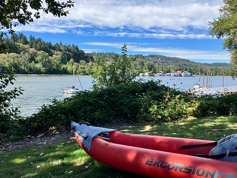 Red kayak in river, orange kayak tip, two kayers, yellow Malibu Two kayak